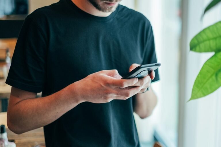 Hands holding an Android phone to install the Muse AI APK