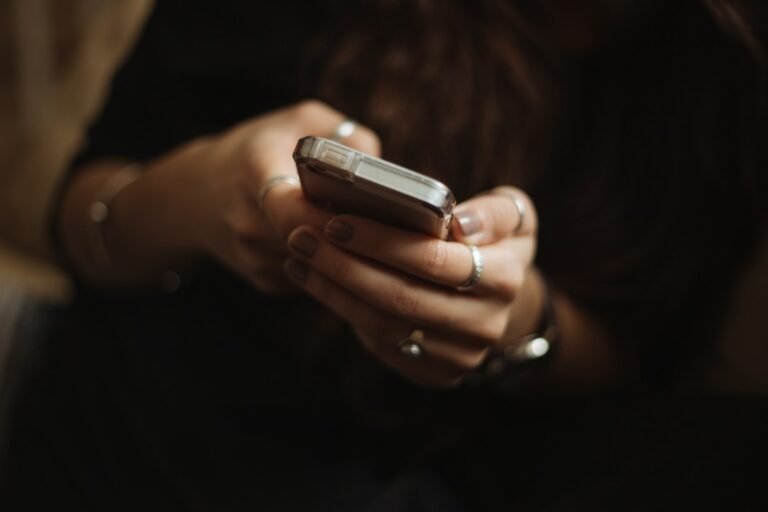 Person checking Muse AI APK free plan and pricing on a smartphone