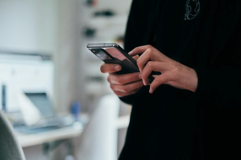 Person holding an Android phone ready to download the Muse AI APK